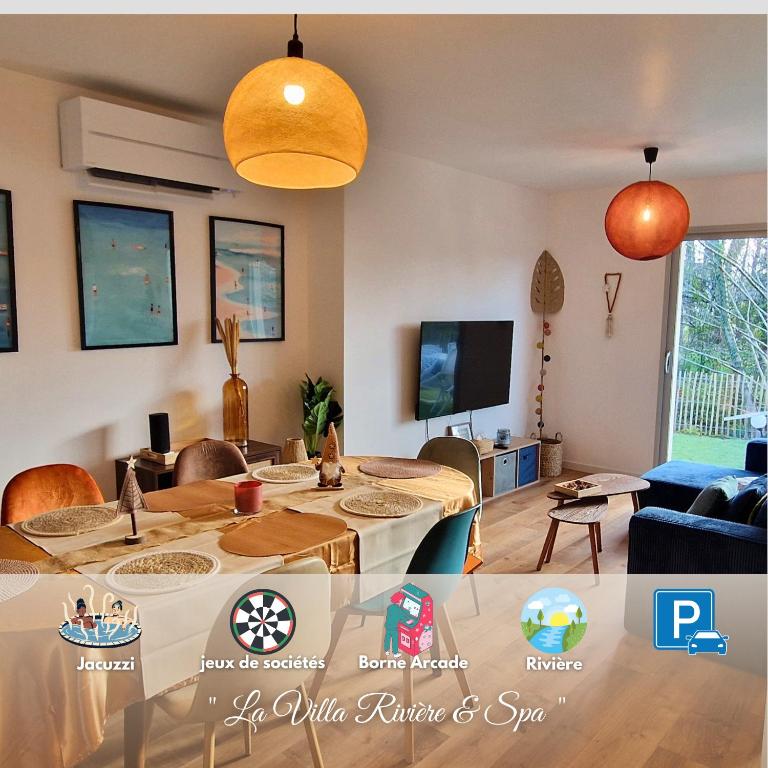 a living room with a table and a tv at La Villa Rivière & SPA in Saint-Laurent-de-Médoc