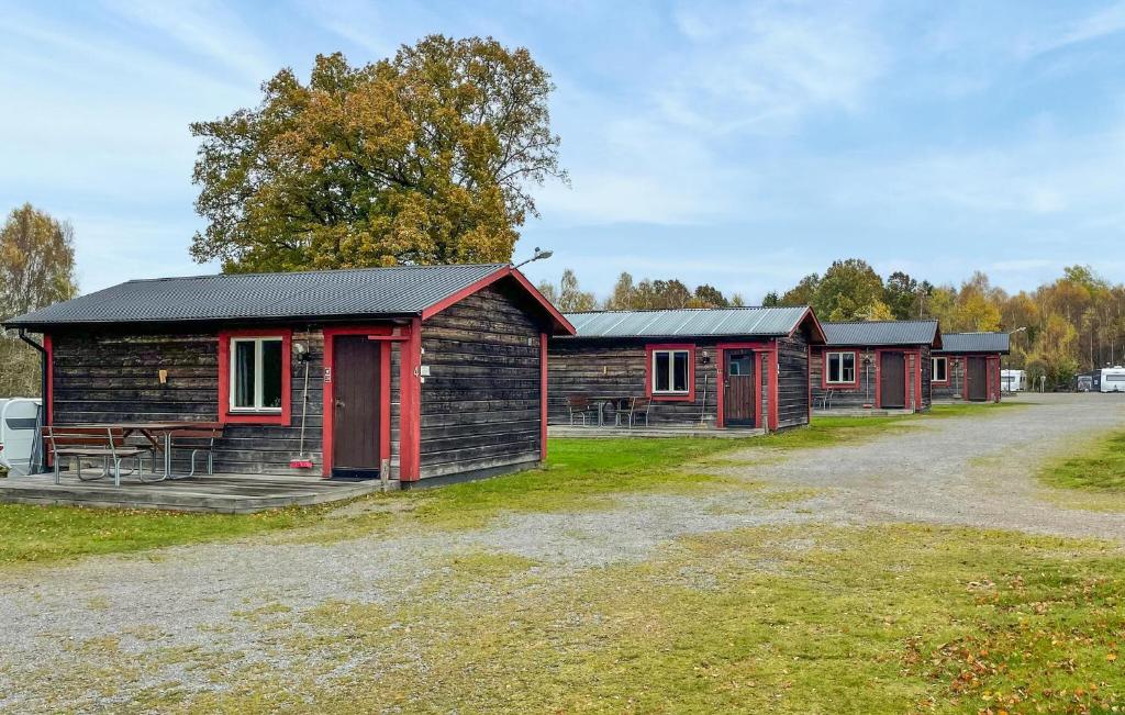 a group of cabins in a field next to a road at 1 Bedroom Lovely Home In Våxtorp in Jonstorp