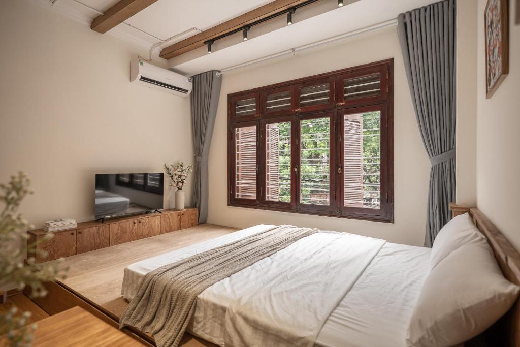 a bedroom with a large bed and a window at Cozy StuHanoi Near Old Quarter in Hanoi