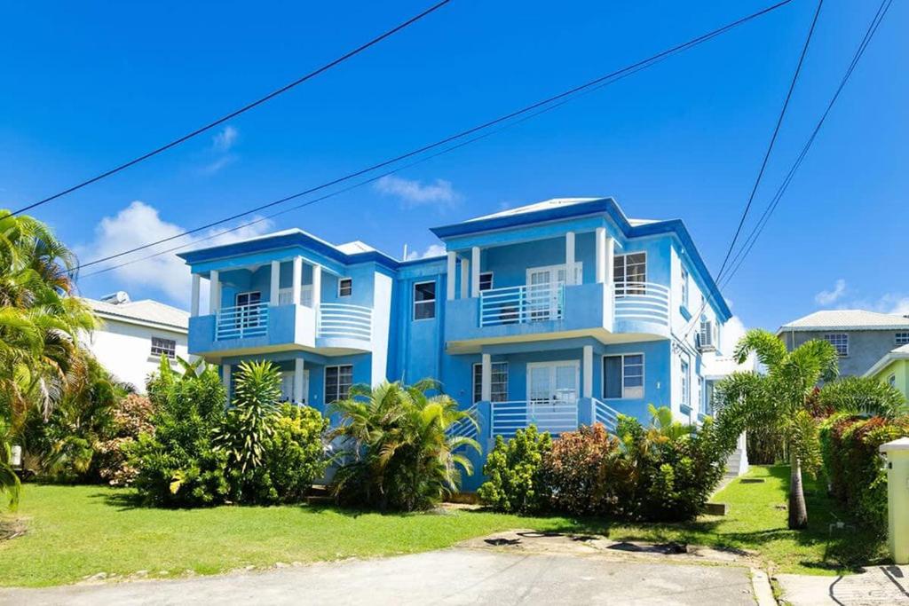a blue and white house with trees in front of it at ZenBreak St Silas 3 bd - #2 in Saint James
