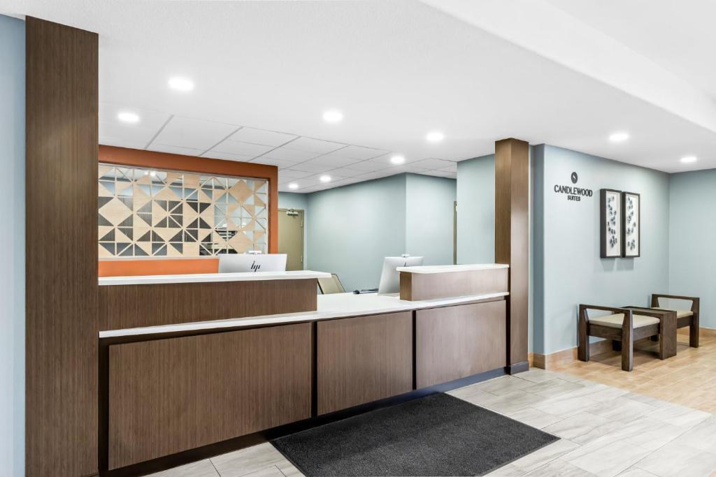 an office lobby with a waiting area with a reception desk at Candlewood Suites Victoria by IHG in Victoria
