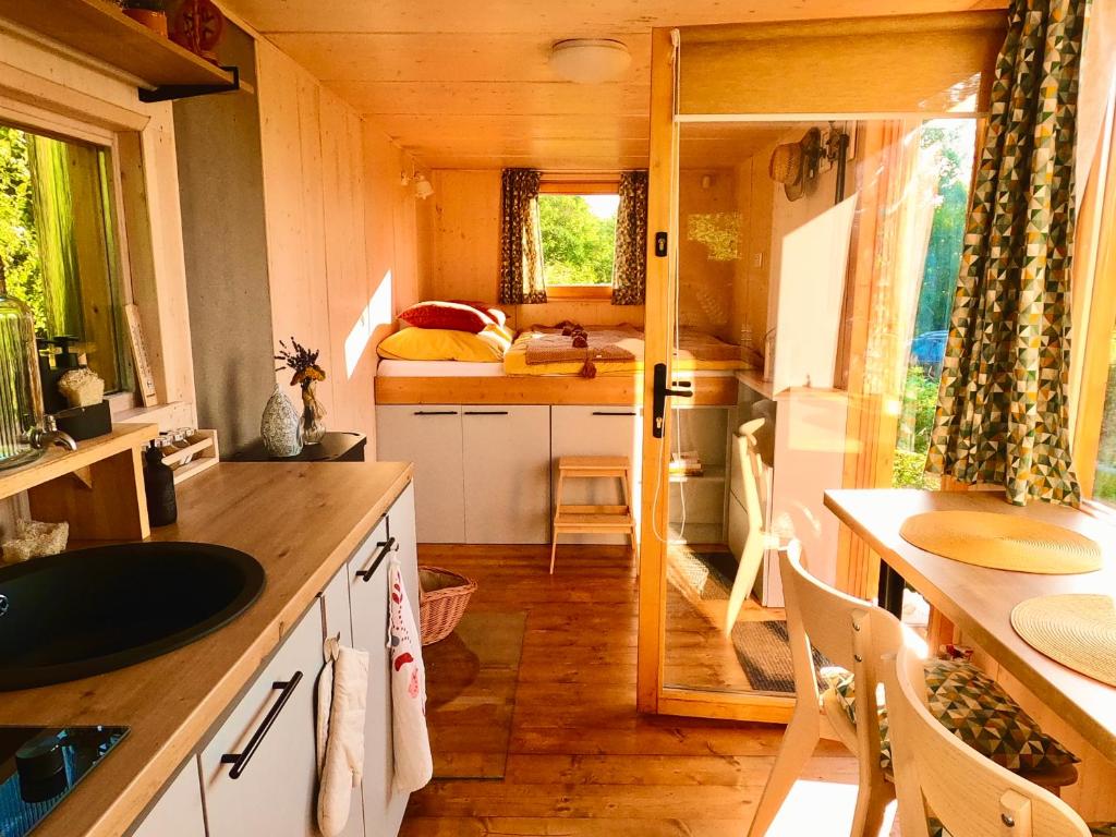 a small kitchen with a sink and a counter top at Off-grid maringotka Cibéba in Rača