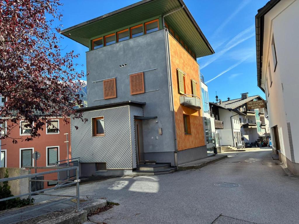 a building on a street next to a building at KOSIS Townhouse mit Spa Zugang im KOSIS Sports Lifestyle Hotel in Fügen