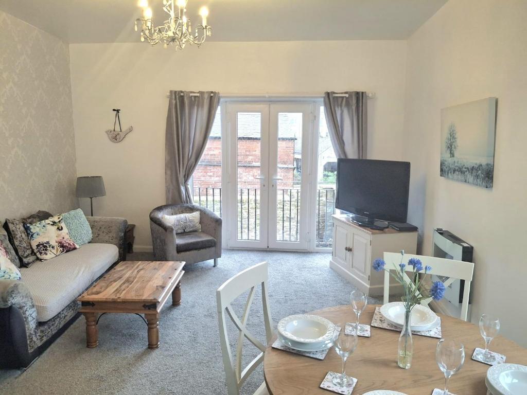 a living room with a couch and a table at Angel Lane Alnwick Apartment in Alnwick