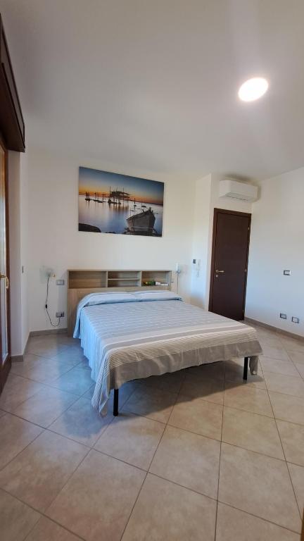 a bedroom with a bed with a painting on the wall at Bed and Bike in Vasto