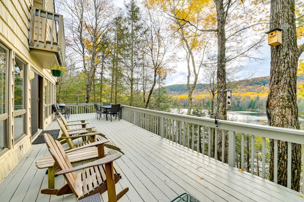 a deck with two chairs and a table on it at Great Barrington Lakeside Getaway with Kayak and Grill in Great Barrington