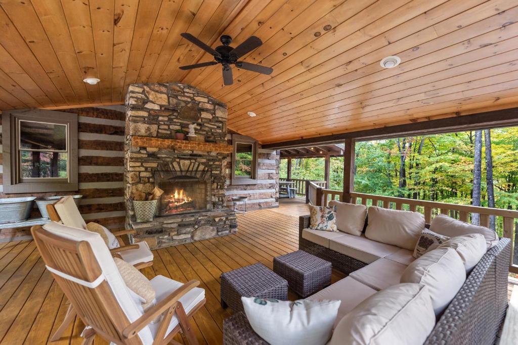 a living room with a couch and a fireplace at Cabin Chateau- Modern Escape with Outdoor Living area with Fireplace & Hot Tub in Baldwin