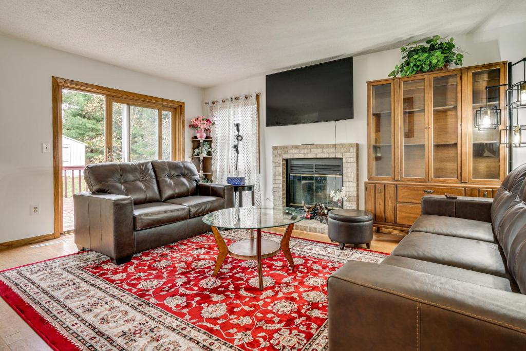 a living room with a couch and a table at 12 Mi to Dtwn St Paul Extended Stay in Woodbury! in Woodbury