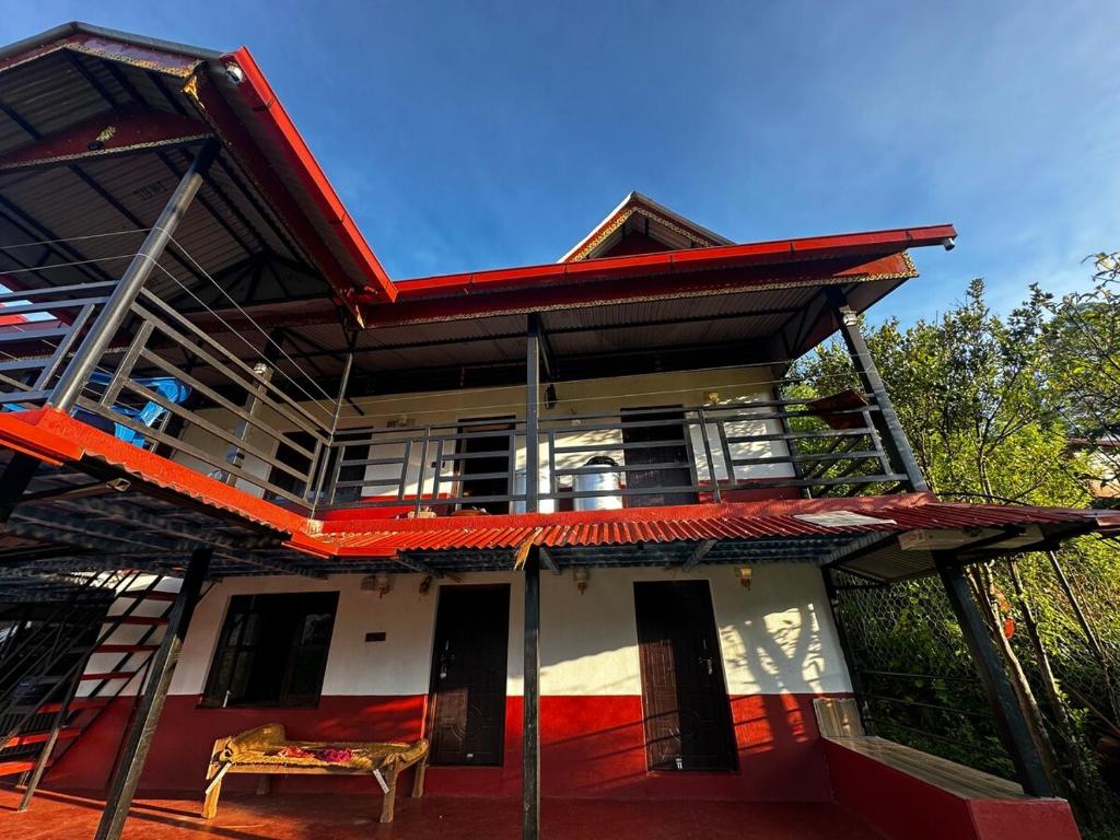 a house with a red roof with a bench in front at Stay with Nature in Kusma