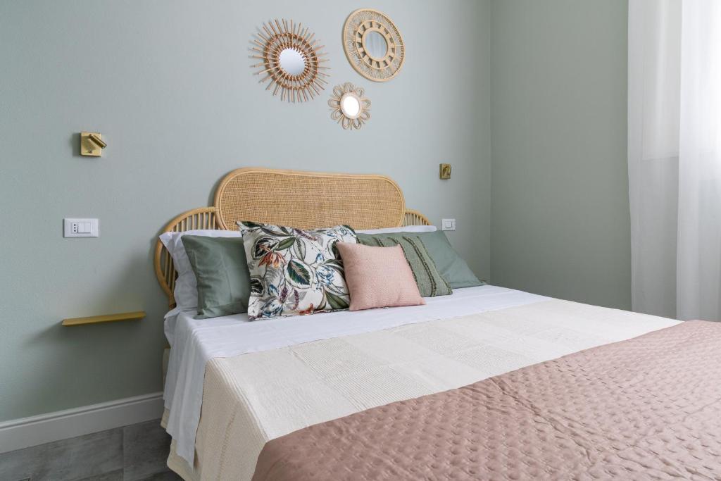 a bedroom with a bed with pillows and a mirror at Casa Lazzari - Giardino Segreto a 3 min da Villa Maria Cecilia Hospital in Lugo