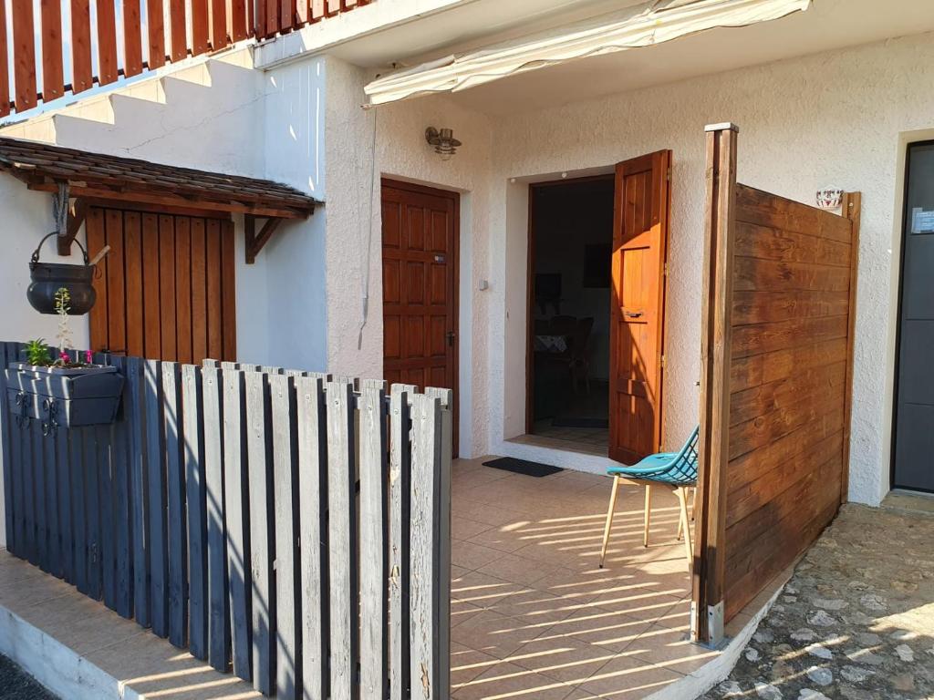 a chair sitting outside of a house with a fence at Le Gite de Pigneux in Truison
