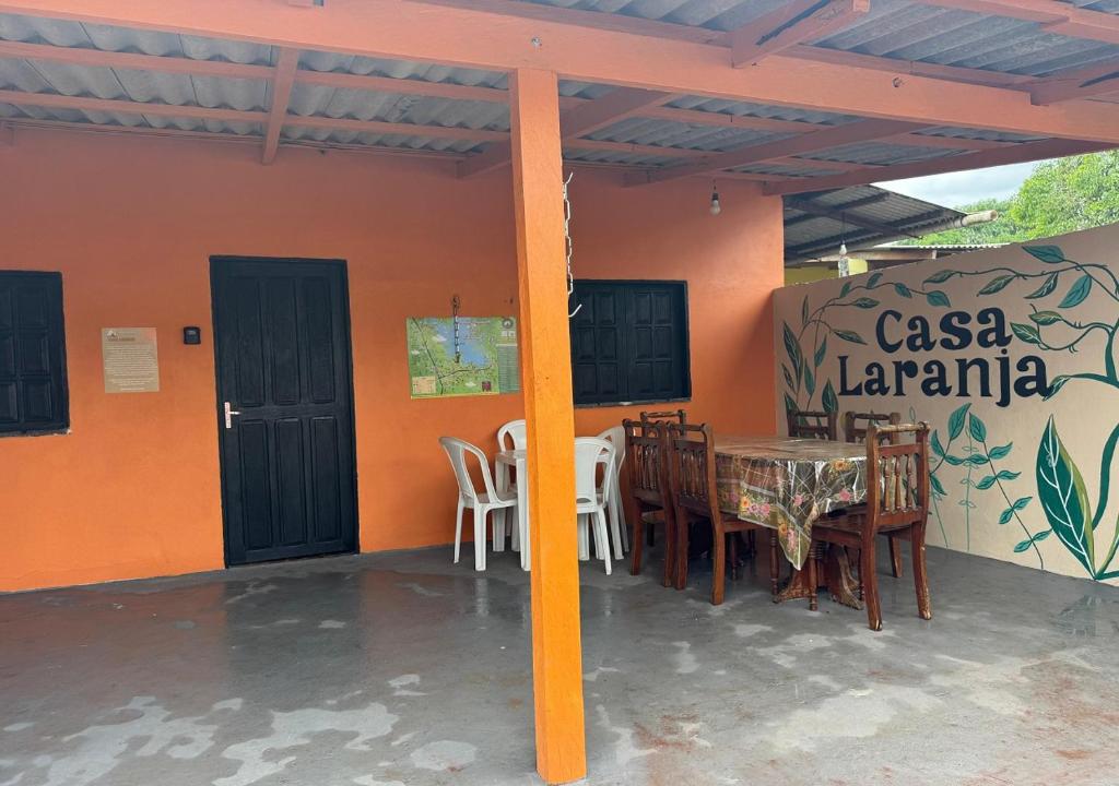 a patio with a table and chairs in a house at Casa Laranja in Presidente Figueiredo