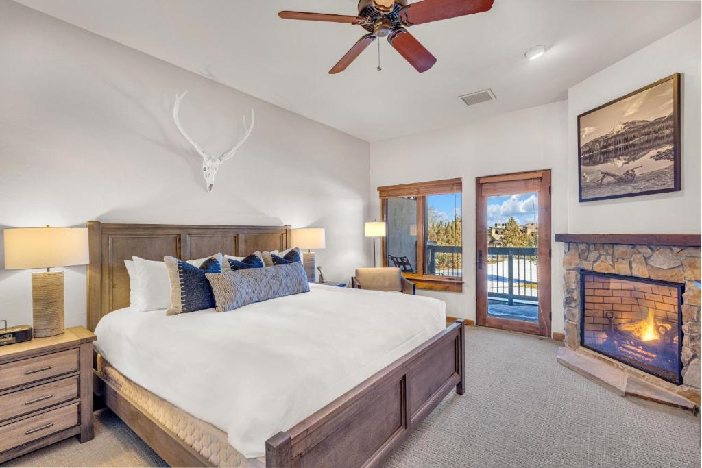 a bedroom with a large bed and a fireplace at Upscale 3 BR Townhouse @ Juniper Preserve Resort in Bend