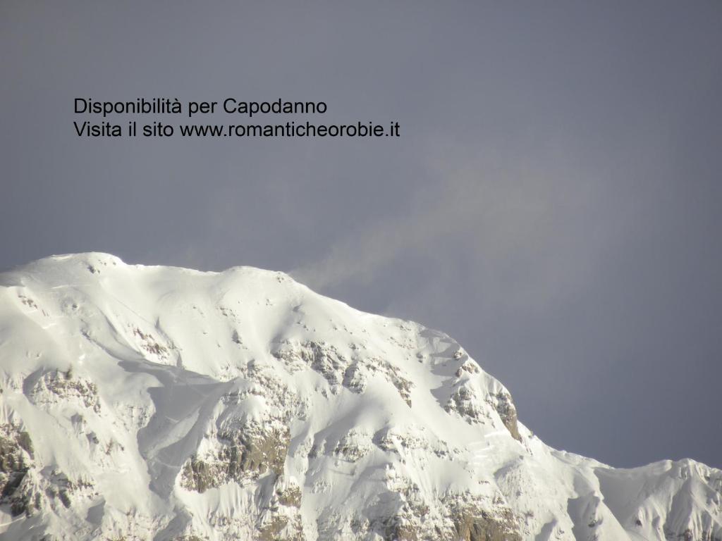 a mountain covered in snow with the sky in the background at Romantiche Orobie B&B in Bordogna