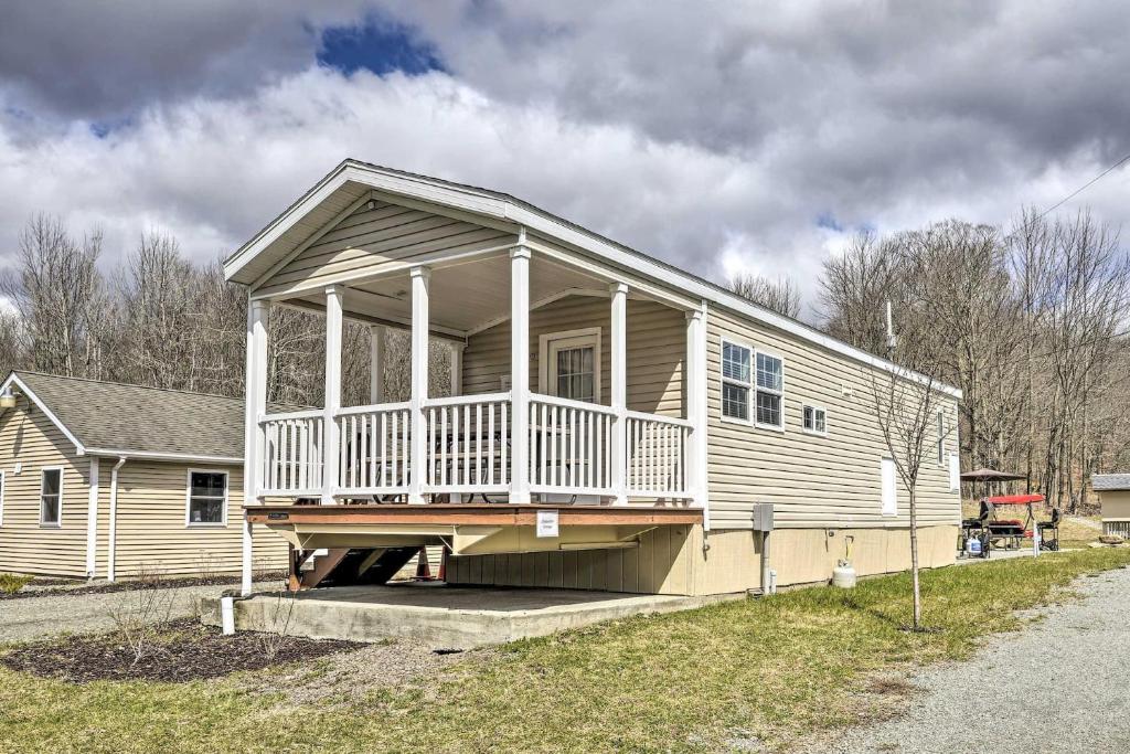 a house with a large porch on the side of it at Tranquil Trails Cabin & Suites Spring Midweek 35 Off in Pleasant Mount