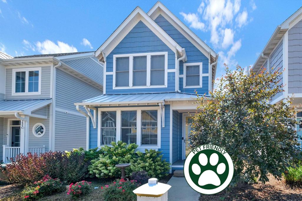 a blue house with a sign in front of it at Zuzu's Petals in Ottawa