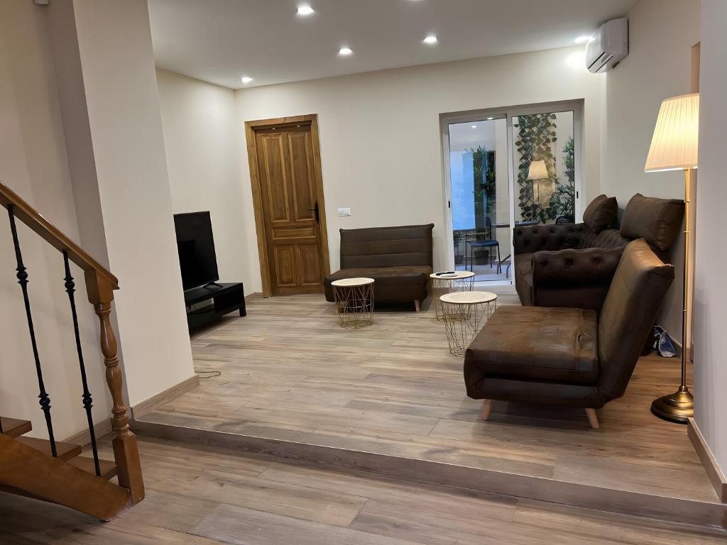 a living room with a couch and a tv at 3 Rooms 3 Bathrooms In The City in Málaga