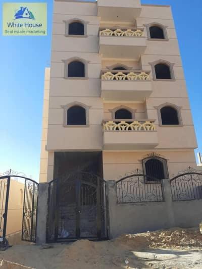 a tall white building with two balconies on it at Party 