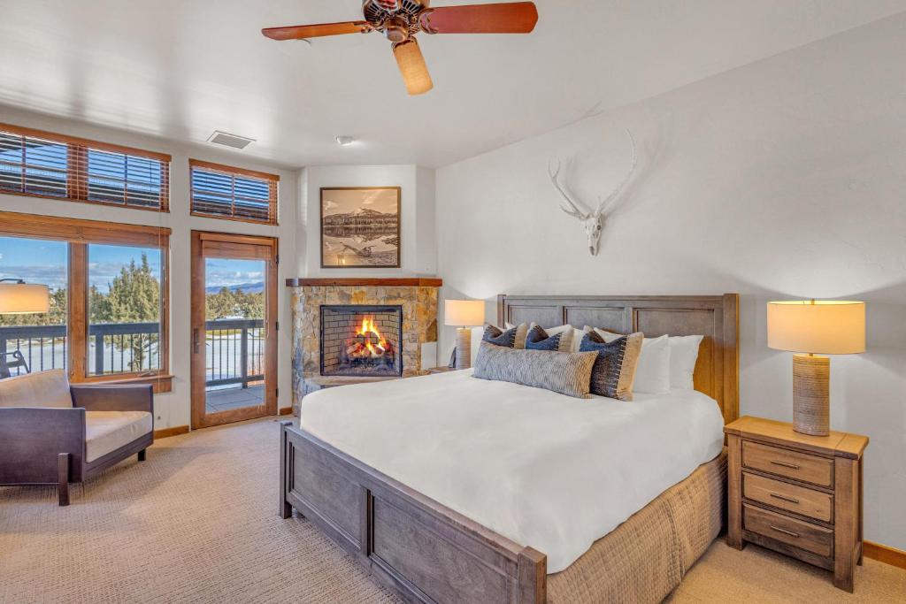 a bedroom with a bed and a fireplace at Upscale 4 BR Townhouse @ Juniper Preserve Resort in Bend