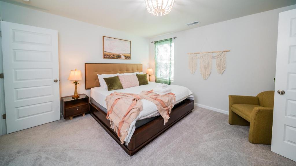 a bedroom with a large bed and a chair at Golf and Beach Getaway in Sunset Beach