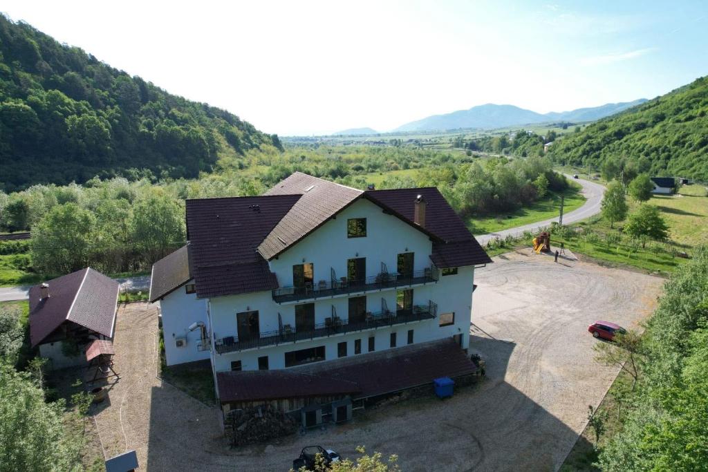 an aerial view of a house in the mountains at Pensiune Marginimea Sibiului in Orlat