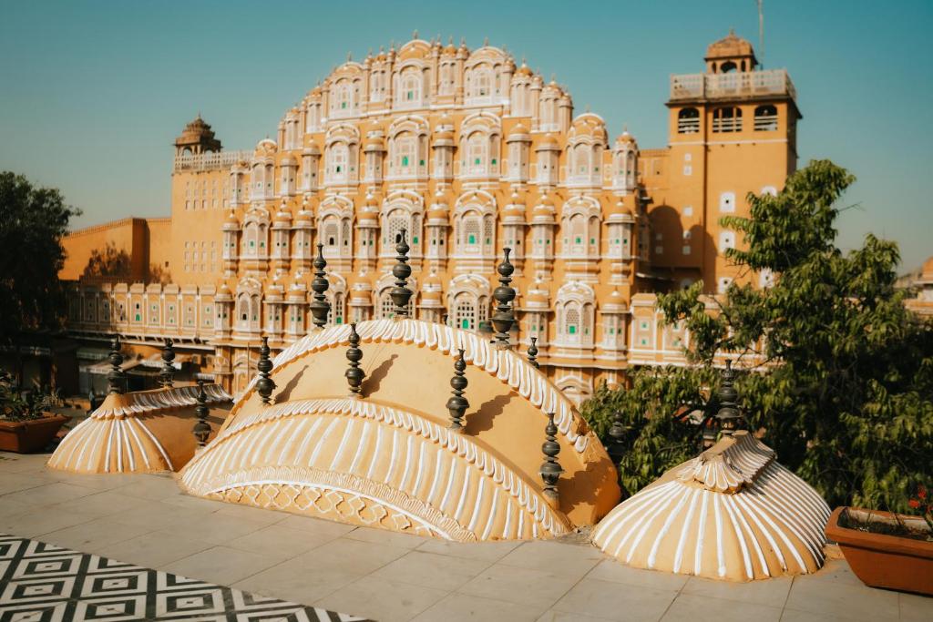 a large building with umbrellas in front of it at Jai Kutir Homestay - Hawa Mahal View in Jaipur
