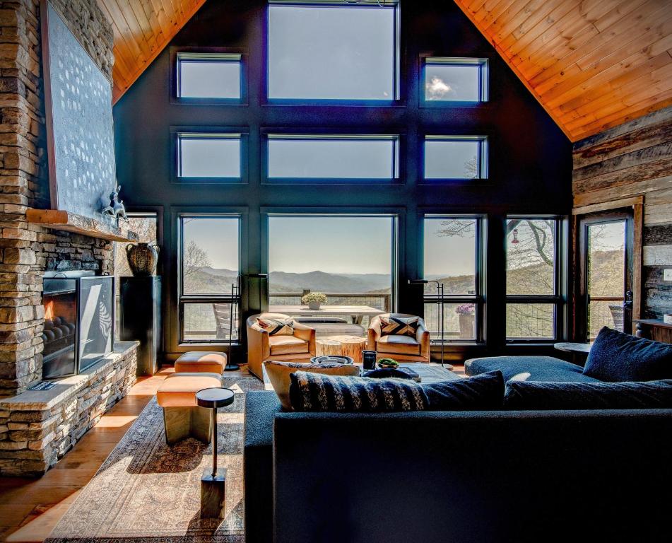 a living room with a couch and a fireplace at Owls Nest in Seven Devils