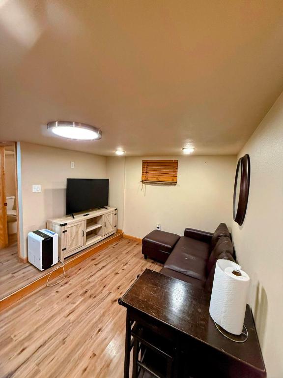 a living room with a couch and a flat screen tv at Dillon Ave Homes in Cheyenne