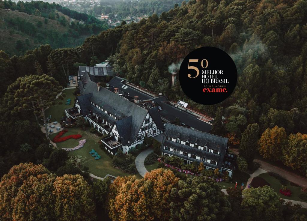 a large building in the middle of a forest at Ort Hotel in Campos do Jordão