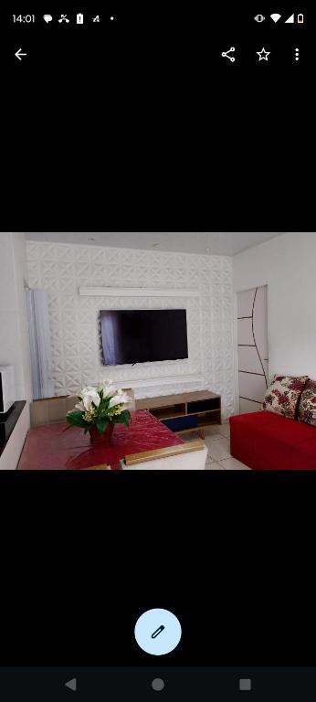 a living room with a flat screen tv on a wall at Casa Cop 30 Belém in Belém