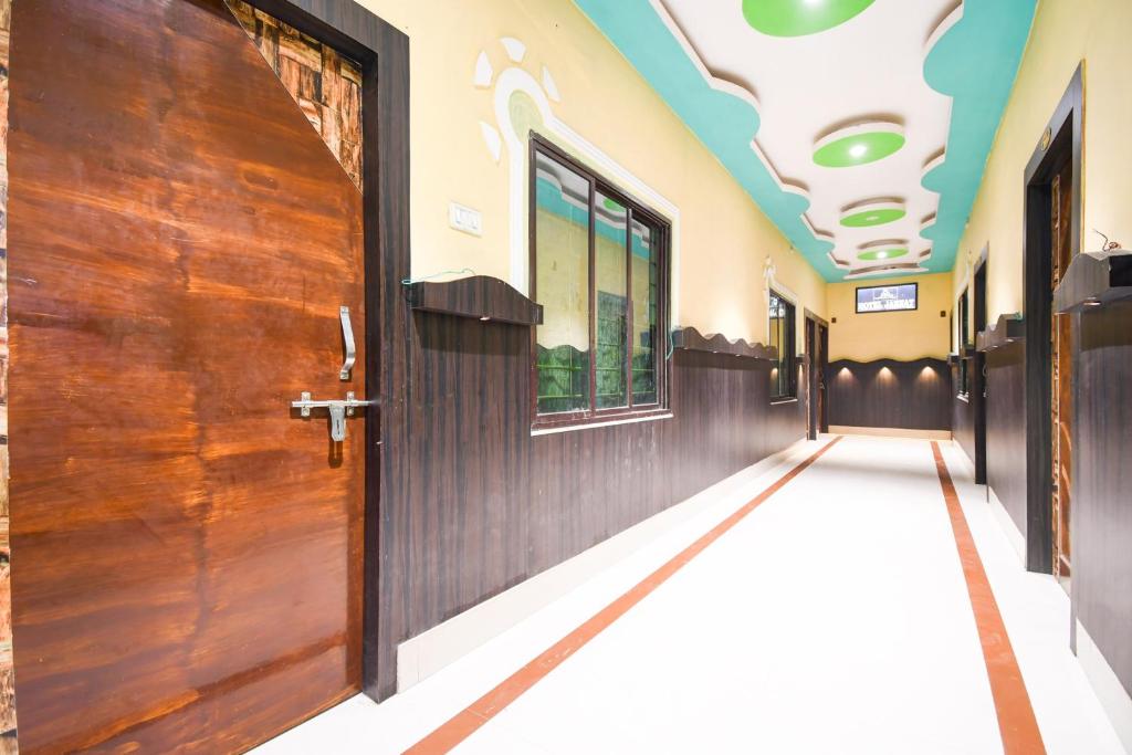 a corridor of a building with a wooden door at Hotel O Jannat in Chupra