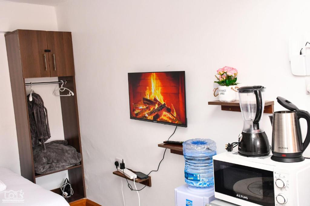 a kitchen with a microwave and a blender on a counter at Luxe-homestay 1 Bed Executive Studio in Eldoret