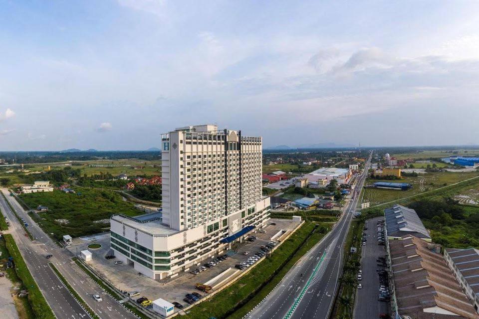 an overhead view of a large white building next to a highway at AnR Studio Suite Inside H Elite Building in Kota Bharu