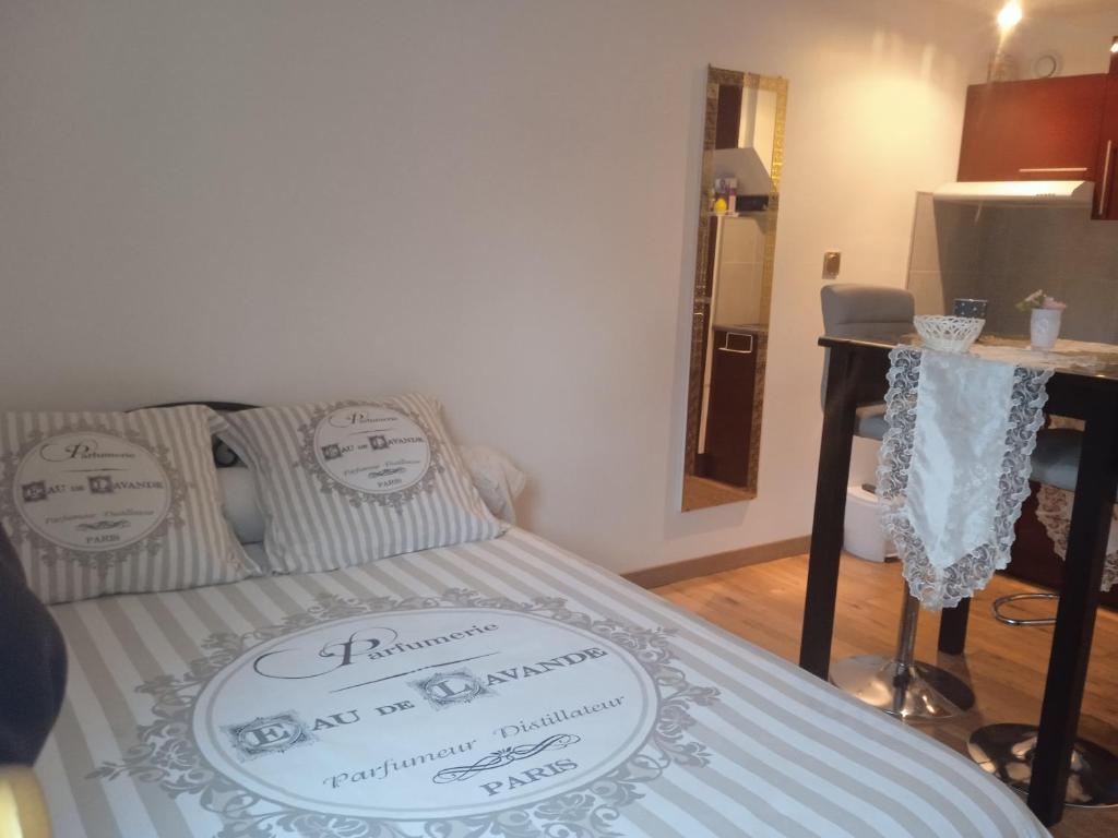 a bed with a sign on it in a room at Le briochin in Saint-Brieuc