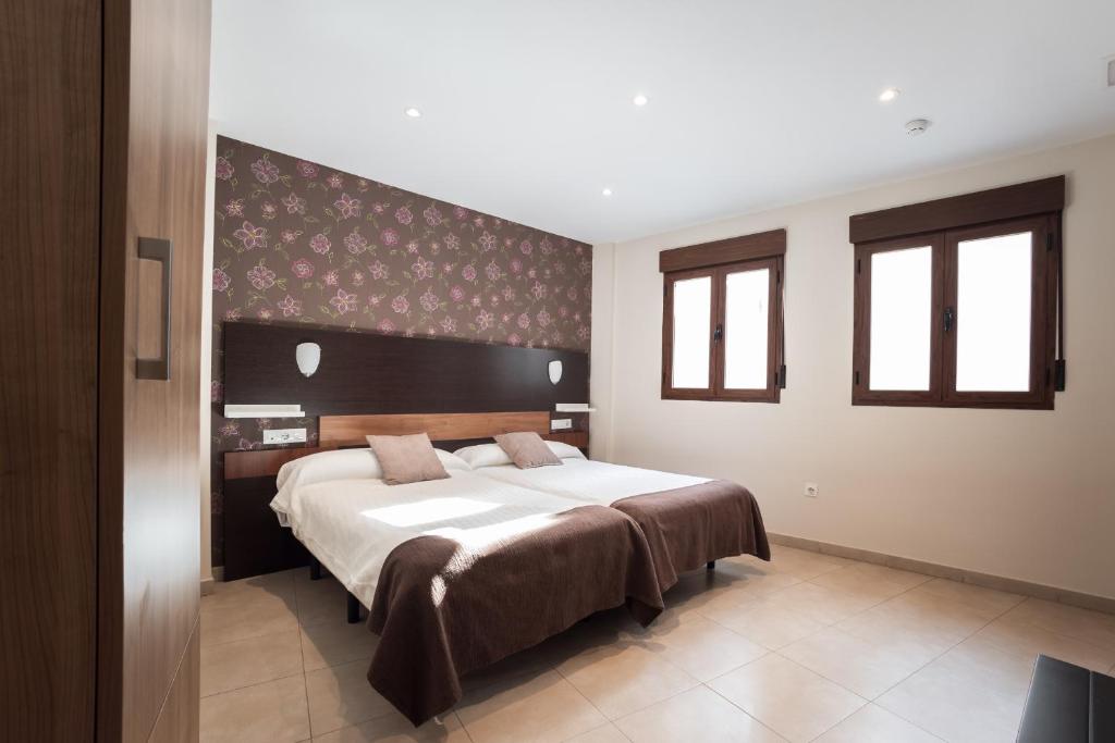 a bedroom with a large bed in a room at Apartamentos Reyes Católicos by Medina Living in Granada