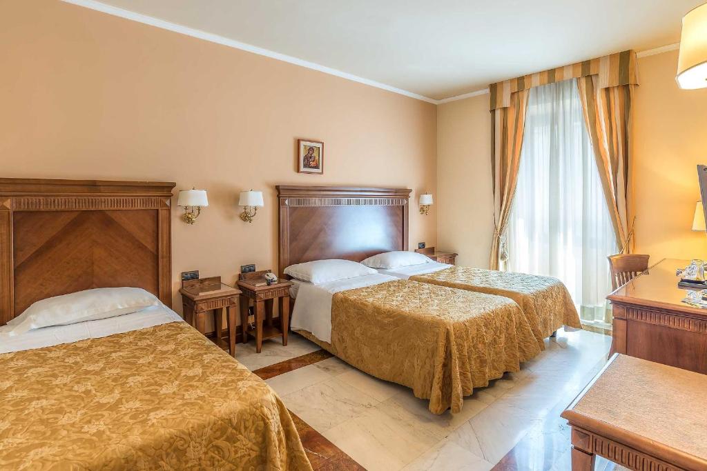 Postel nebo postele na pokoji v ubytování Tmark Hotel Vaticano