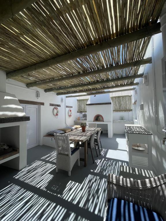 a kitchen with a table and chairs and a fireplace at Bougain Villa in Paternoster