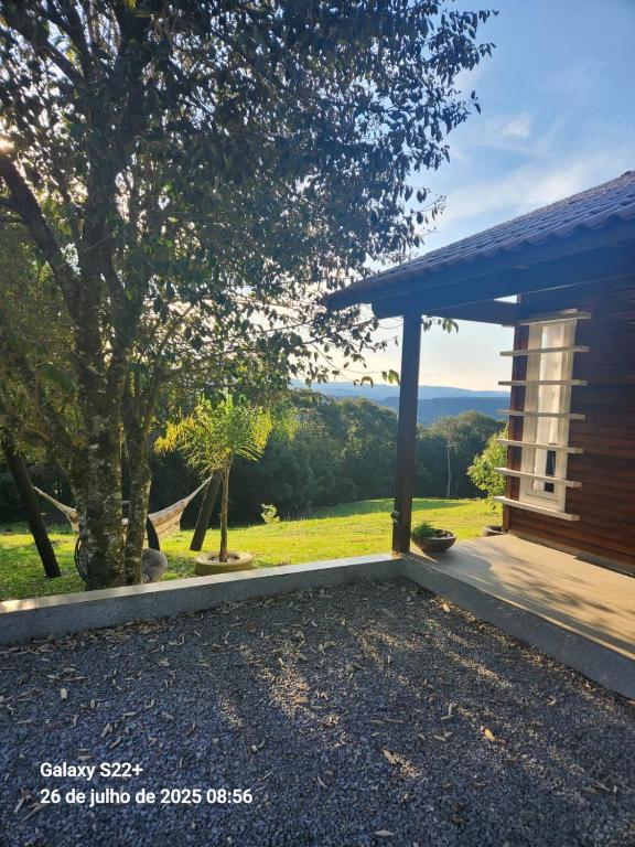 a porch of a house with a view at Chale Vale Carahá Lavanda in Gramado