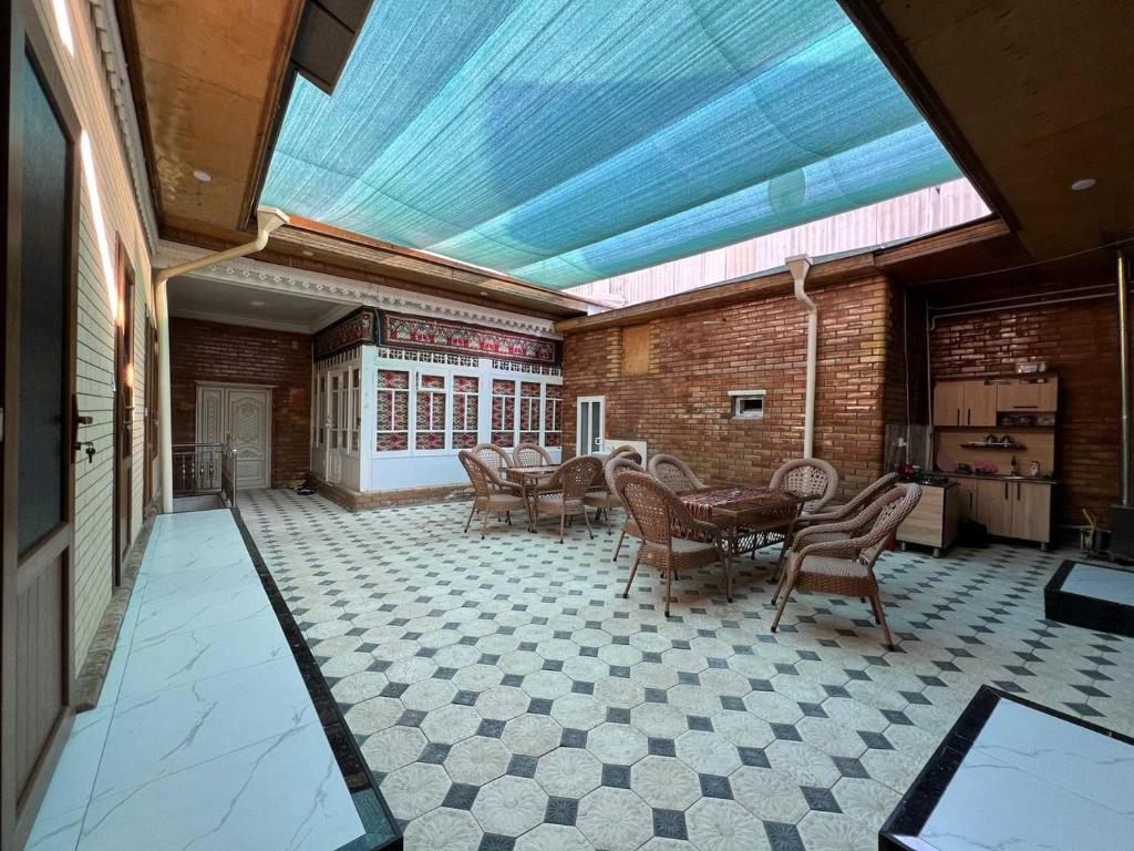 a large room with a glass ceiling with chairs and tables at Shahina in Samarkand