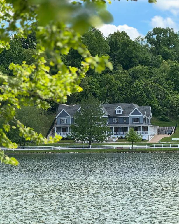 a large house on the shore of a lake at Inns at St Albans in Saint Albans