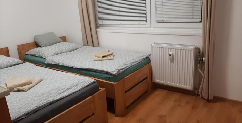 a room with two twin beds and a window at Byt v centre mesta in Bardejov