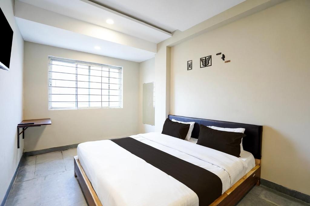 a bedroom with a large bed in a room at Hotel O Eternity Stays in Harsola