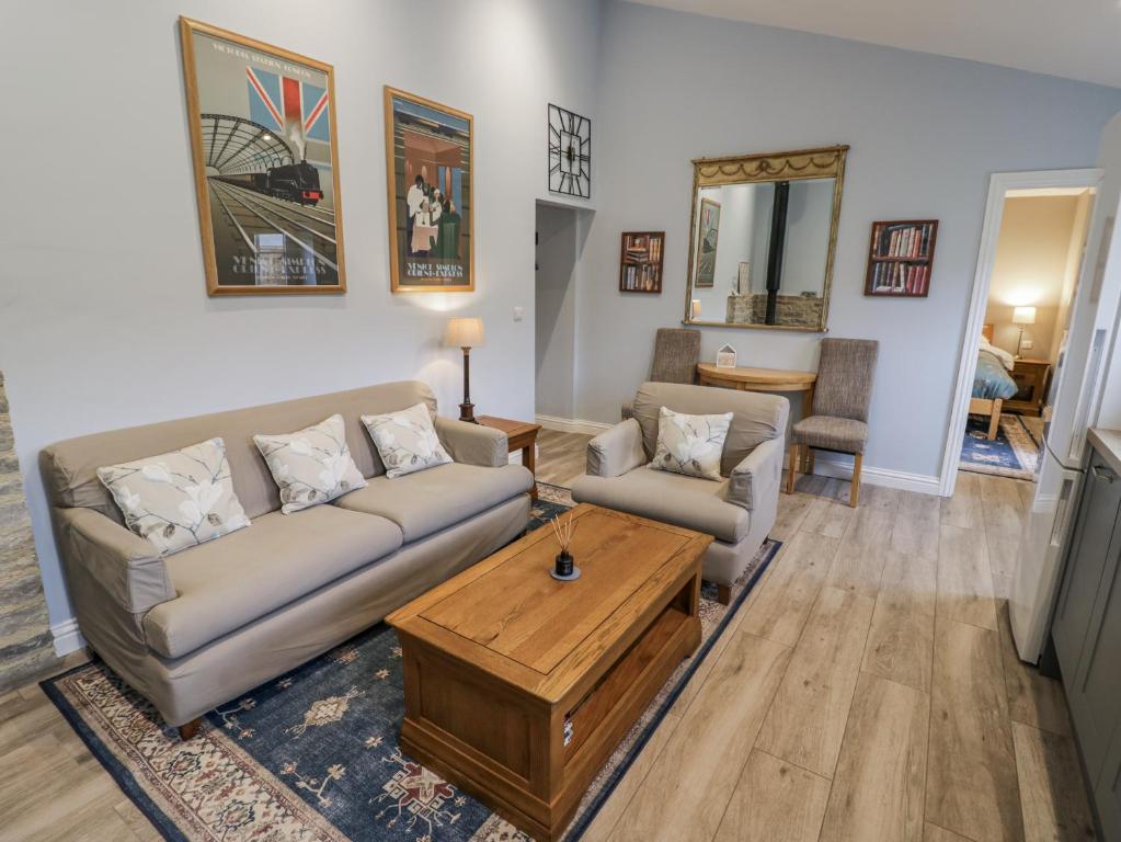 a living room with a couch and a coffee table at Rose Stables in Carterton