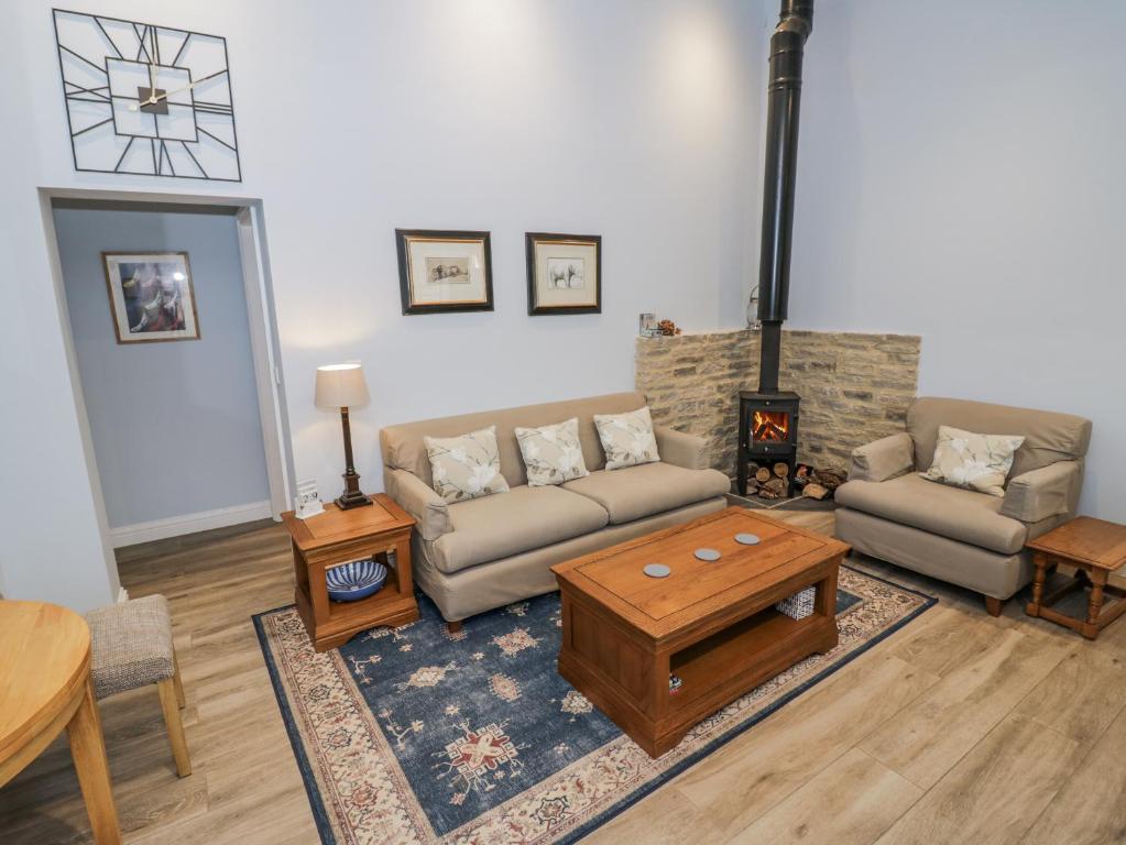 a living room with a couch and a coffee table at Lily Stables in Bampton