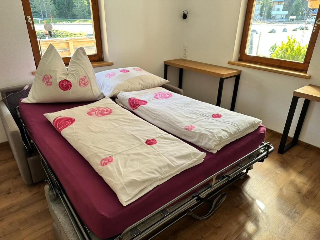 two beds with pink and white sheets and pillows at apart-gerlos in Gerlos