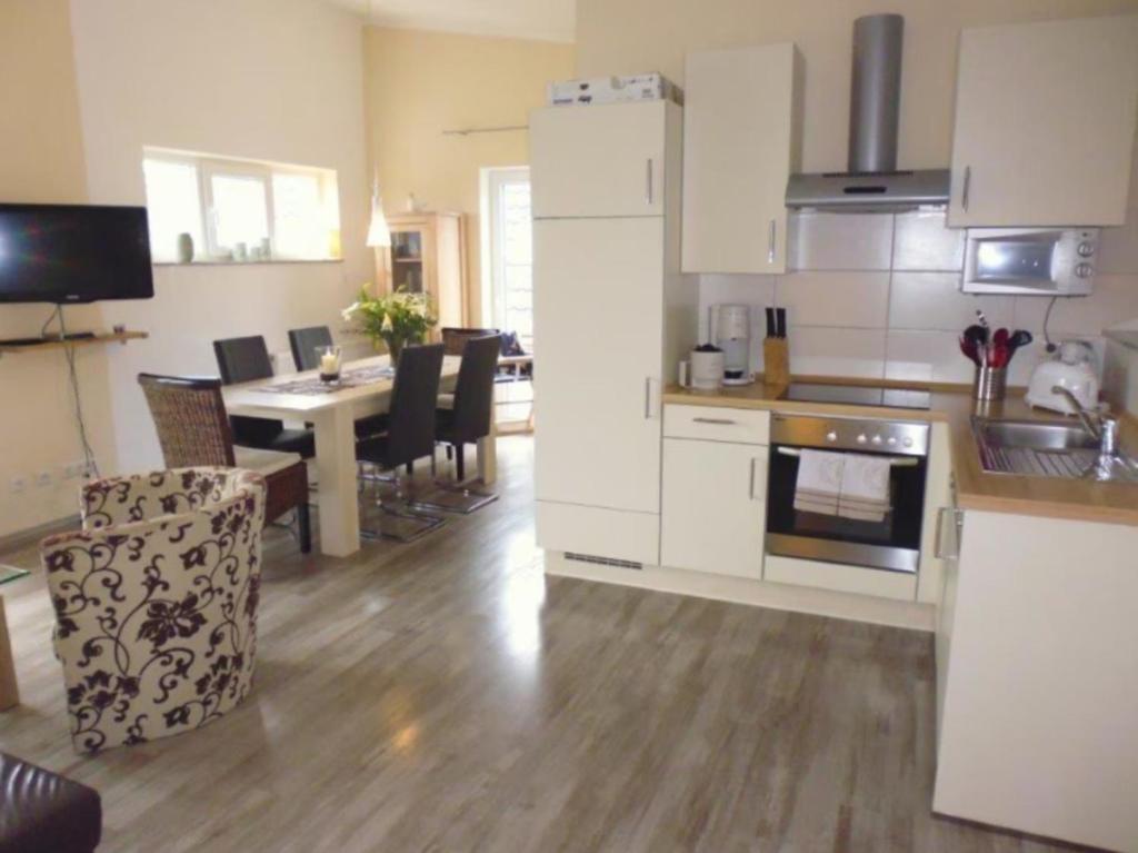 a kitchen and dining room with a dining table and a kitchen at Ferienhaus "Schöne Aussicht" in Neue Tiefe Fehmarn