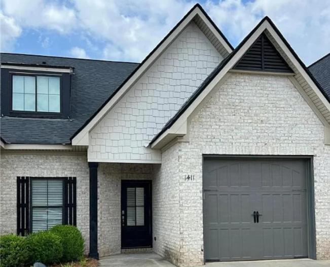een wit bakstenen huis met een garage bij War Eagle Landing a 4BR and 3BA Family-Friendly Auburn Retreat in Auburn