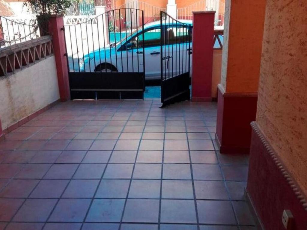 a gate to a parking lot with a car at Leisurely Apartment in Lepe with Swimming Pool in La Antilla
