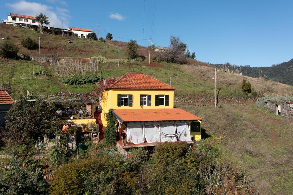 una casa amarilla sentada en la cima de una colina en La Maison ZiaZen, en Porto da Cruz