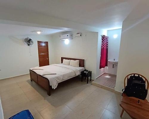 a bedroom with a bed and a red curtain at Villa funk monk - swimming pool in Kuilapayam